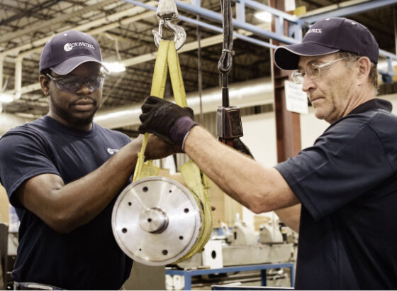 Men hoisting rotary die